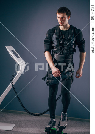 man training on stepper with electric muscle 38905231