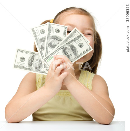 Cute little girl is covering her eyes with dollars 38906538