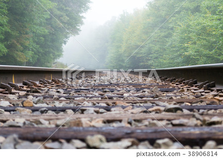 Train track into the fog 38906814