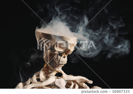 Skeleton with smoke coming out of open skull Skeleton with smoke coming out of open skull 38907335