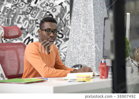 Young Black Man in the office behind his desk 38907492