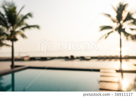 Abstract blur outdoor swimming pool with coconut palm tree 38911117