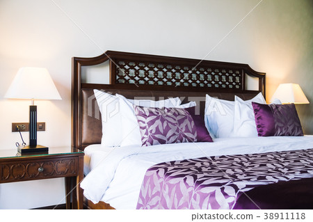 Comfortable pillow on bed 38911118