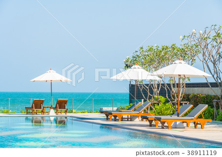 Beautiful umbrella and chair around swimming pool in hotel and resort 38911119