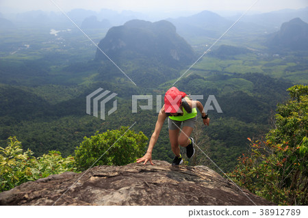 woman running up to the mountain top . woman running up to the mountain top . 38912789