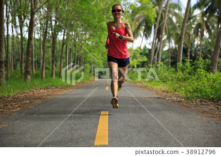 fitness woman runner running on forest trail 38912796