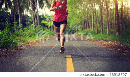 fitness woman runner running on  forest trail 38912797