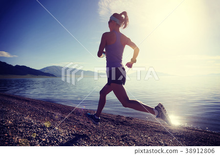 fitness sporty woman running on rocky seaside fitness sporty woman running on rocky seaside 38912806