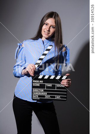 Young beautiful brown-haired woman with a movie cracker 38914526