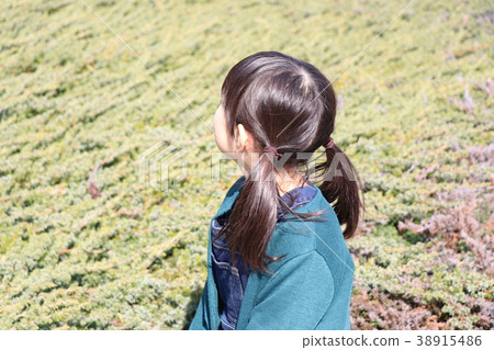 A girl looking up at the sky 38915486