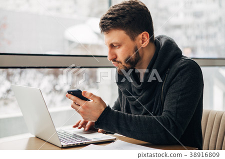 Male freelancer connecting to wireless via laptop 38916809