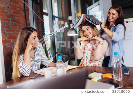 Three funny young students having fun while 38918000
