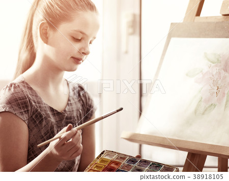 Artist painting on easel in studio. Girl paints Artist painting on easel in studio. Girl paints 38918105