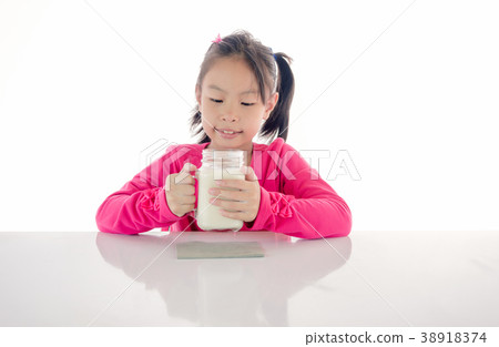 girl holding a glass of milk girl holding a glass of milk 38918374