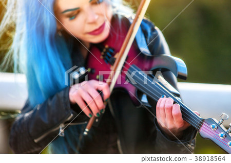 Woman perform music on violin park outdoor. Girl 38918564