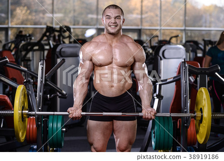 Brutal strong bodybuilder athletic men pumping up muscles with d Brutal strong bodybuilder athletic men pumping up muscles with d 38919186