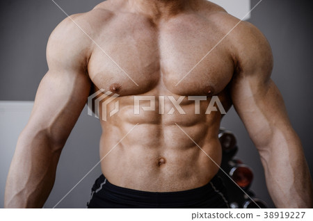 Brutal strong bodybuilder athletic men pumping up muscles with d 38919227