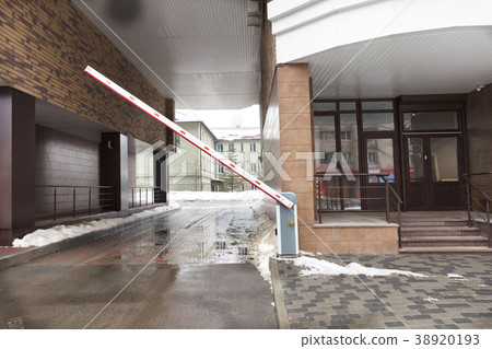 Automatic barrier gates to entry of the building Automatic barrier gates to entry of the building 38920193