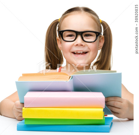 Cute cheerful little girl reading book Cute cheerful little girl reading book 38920835