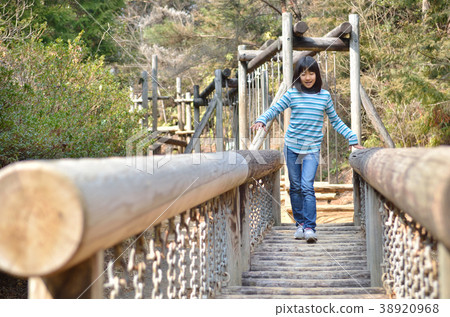 Girls playing with park play equipment 38920968