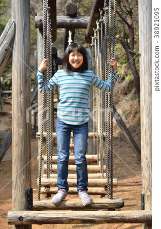 Girls playing with park play equipment 38921095