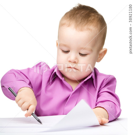 Cute little boy is drawing with pen 38921180