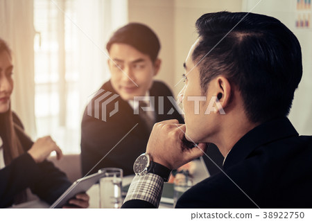 Business man is thinking hard in a team meeting 38922750