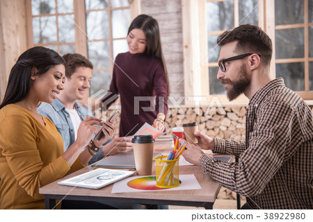 Delighted smart people sitting in the office Delighted smart people sitting in the office 38922980