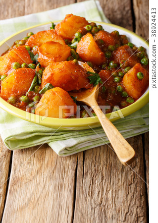 Spicy Indian Aloo Matar potatoes and green peas Spicy Indian Aloo Matar potatoes and green peas 38924413
