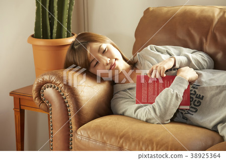 A woman relaxing in the room A woman relaxing in the room 38925364