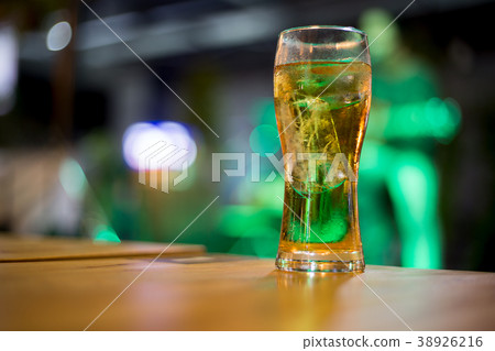 The liquor in the glass is on the table. 38926216