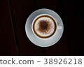 Coffee in a white cup on a wooden table. 38926218