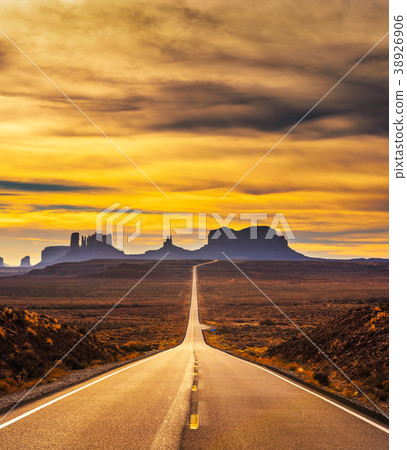 Desert road leading to Monument Valley at sunset Desert road leading to Monument Valley at sunset 38926906
