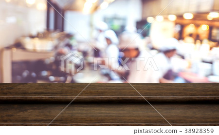 Empty step dark wood table with blur chef cooking Empty step dark wood table with blur chef cooking 38928359