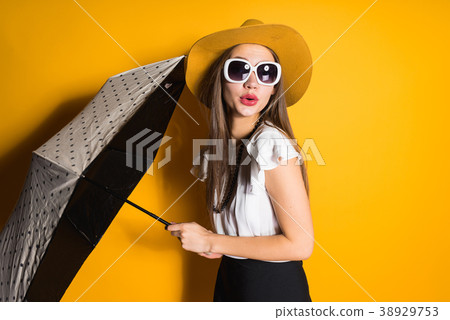 girl  in sunglasses and fashionable hat posing 38929753
