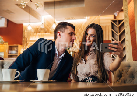 Happy young couple taking selfie with smart phone Happy young couple taking selfie with smart phone 38929830