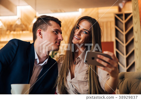 Happy young couple taking selfie with smart phone Happy young couple taking selfie with smart phone 38929837