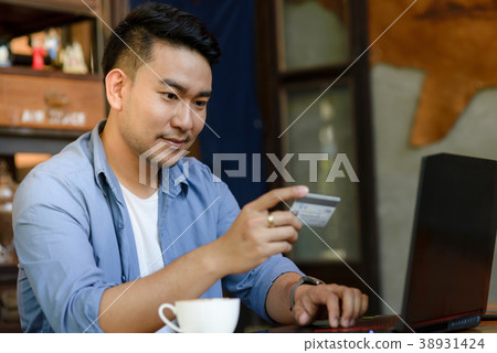 Making online bank transfer,man holds credit card Making online bank transfer,man holds credit card 38931424