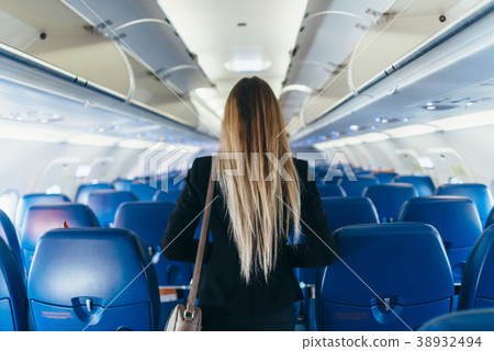 Back view of young woman wearing formal suit 38932494