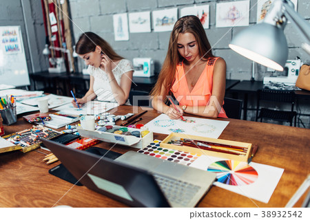 Designers workspace. Two female artists drawing 38932542