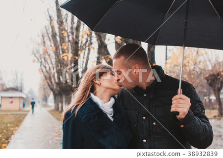 Young couple under an umbrella 38932839