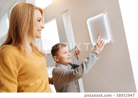Happy nice boy looking at the control panel 38932947