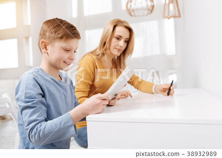 Joyful happy boy using a tablet 38932989