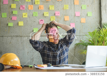 Stressed man with message on sticky notes  38933150
