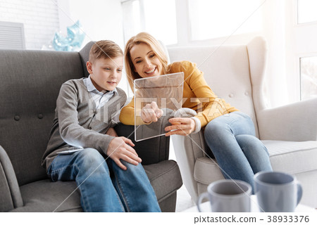 Joyful positive mother and son resting at home 38933376