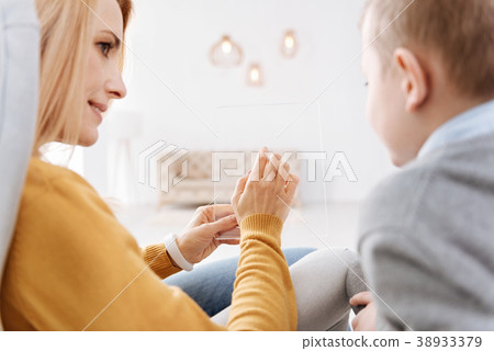 Nice pleasant woman holding a tablet Nice pleasant woman holding a tablet 38933379