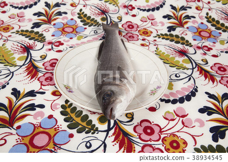 bass fish inside a flower plate bass fish inside a flower plate 38934545