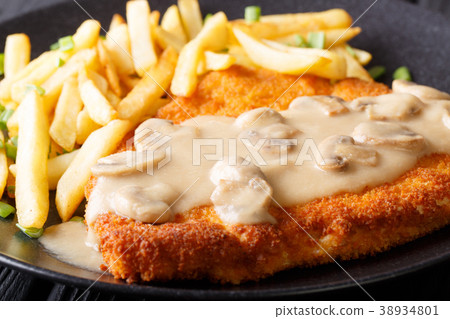 Jaeger schnitzel with French fries and mushrooms Jaeger schnitzel with French fries and mushrooms 38934801
