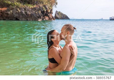 Young hipster couple of woman and man on beach Young hipster couple of woman and man on beach 38935767