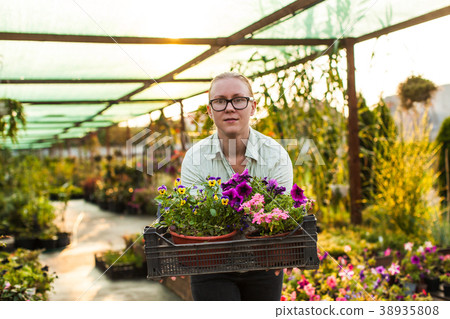 Happy gardener with plant 38935808